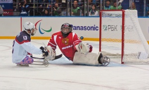 photo by Katie Harris Wounded Warrior Project veteran, Joshua Sweeney, scores the only, and winning, goal during the USA vs. Russia gold medal Sled Hockey game during the 2014 Winter Paralympics in Sochi, Russia.